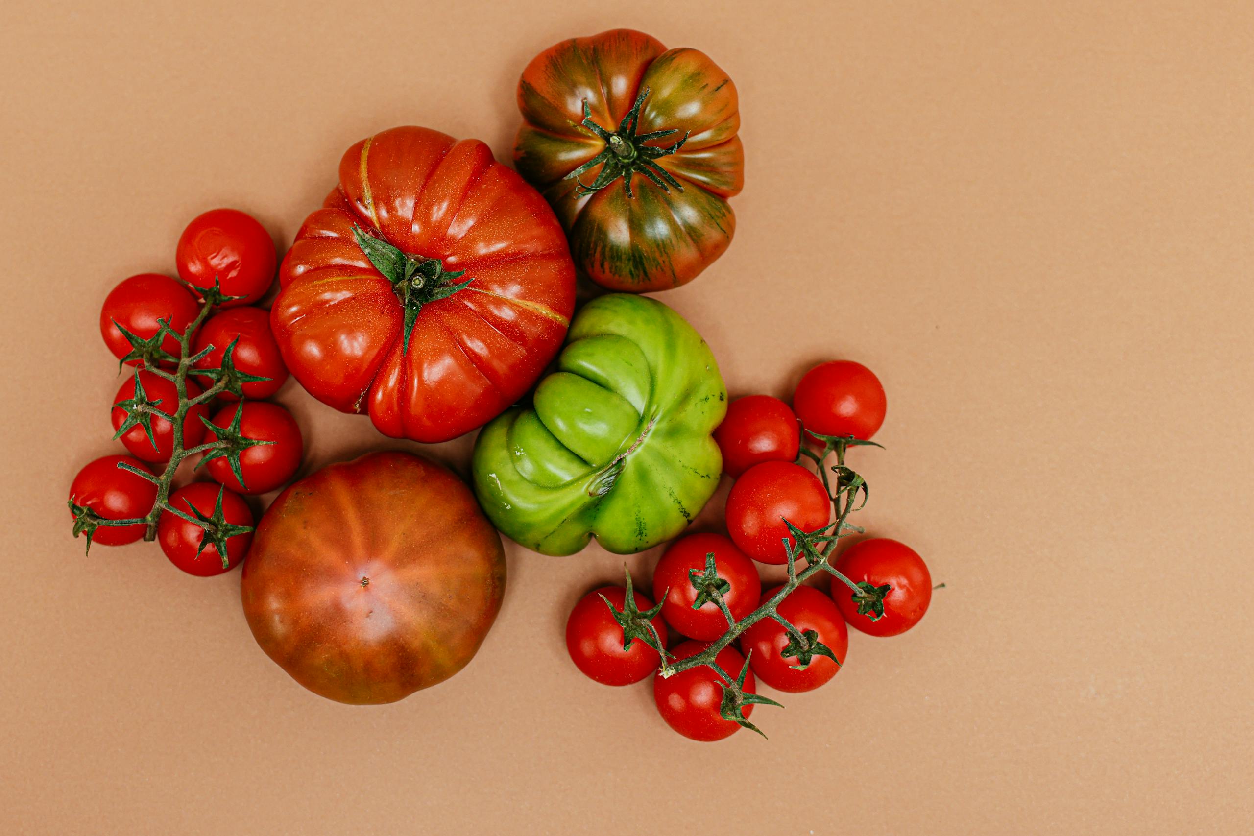 Assorted heirloom tomatoes on a flat surface showcasing vibrant colors.